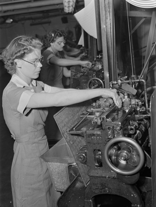 Women in industry. Tool production. Arms for the love of America! The capable young woman whose strong hands guide this cutoff machine is one of a Midwest drill and tool factory's many women employees. Almost 1,000 women have recently been employed in this comparatively new plant; sole men workers, other than foreman, are those in the heat treating department. Republic Drill and Tool Company, Chicago, Illinois, photo by Ann Rosener, 1942.