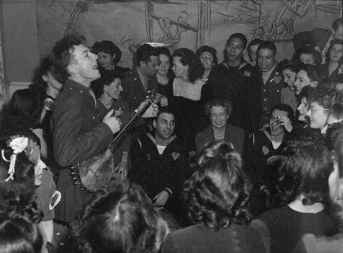 Washington, D.C. Pete Seeger, noted folk singer entertaining at the opening of the Washington labor canteen, sponsored by the United Federal Labor Canteen, sponsored by the Federal Workers of American, Congress of Industrial Organizations (CIO), photo by Joseph A. Horne, 1944