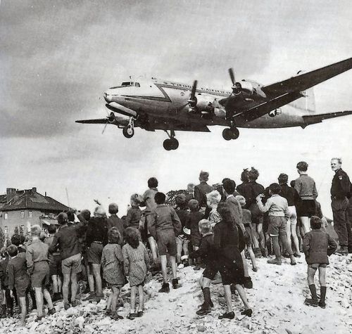 Berliners watch a C-54 Skymaster land at Tempelhof Airport, 1948